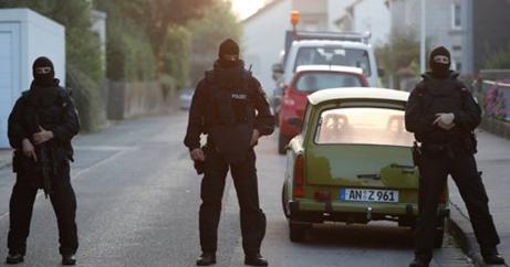 Special police officers secure a street near the house where a Syrian man lived before the explosion in Ansbach, southern Germany, Monday, July 25, 2016