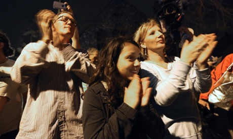 Onlookers applaud first responders departing after their successful operation to capture 19-year-old Boston bombing suspect Dzhokhar Tsarnaev on in Watertown, Massachusetts.